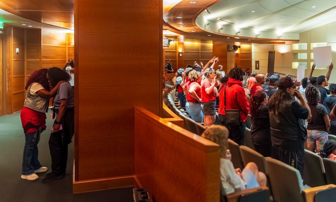 Two women embracing at Kilyn Lewis rally