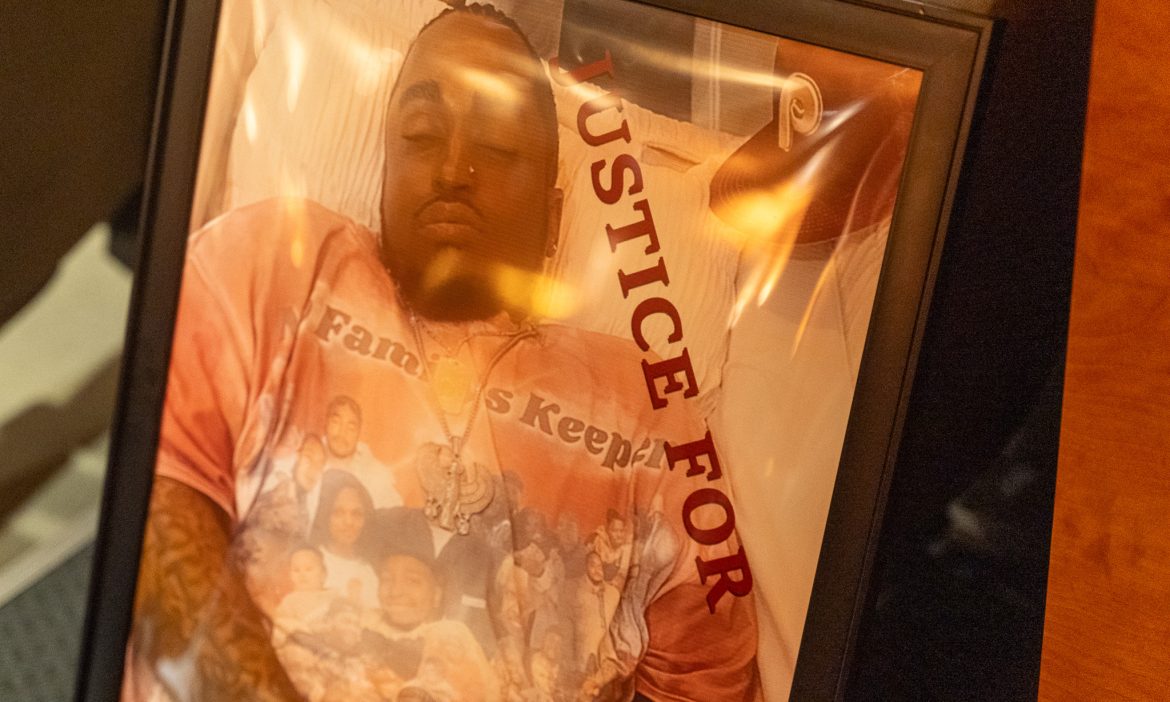 Close-up of the framed 'Justice for Kilyn' memorial portrait showing Kilyn Lewis